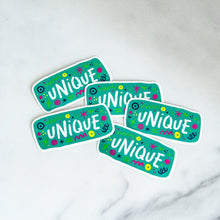 Load image into Gallery viewer, Vinyl die cut stickers with the word &quot;unique&quot; and sketchy elements surrounding the word. 