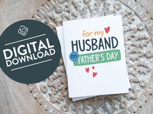 Load image into Gallery viewer, A greeting card laying on a wooden table with some cut wood details. The card features the words “For my Husband on Father&#39;s Day” with small hearts around it. The words &quot;digital download&quot; are featured in a circle on top of the image. 