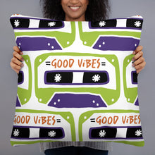 Load image into Gallery viewer, A woman holding a pillow. The white pillow features the artwork on a white background with an illustrated cassette tape pattern with the words &#39;good vibes.&#39;