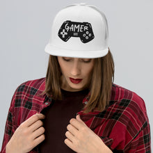 Load image into Gallery viewer, A woman in a red plaid shirt wearing a white trucker hat. The hat features an embroidered design with an illustrated game controller with the word &#39;gamer&#39; inside the illustration.  