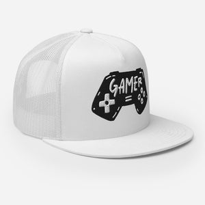 A white trucker hat on a white background showing an angel view of the hat. The hat features an embroidered design with an illustrated game controller with the word 'gamer' inside the illustration.  