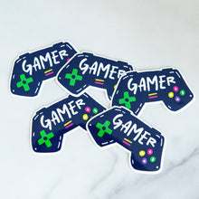 Load image into Gallery viewer, Vinyl die cut stickers with the word &quot;gamer&quot; inside an illustrated game contoller.