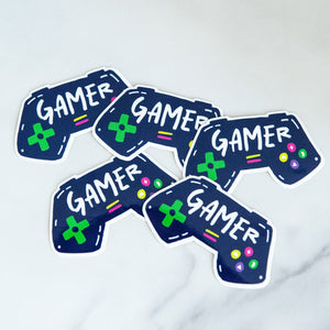 Vinyl die cut stickers with the word "gamer" inside an illustrated game contoller.