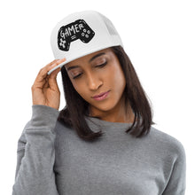 Load image into Gallery viewer, A woman in a gray shirt wearing a white trucker hat. The hat features an embroidered design with an illustrated game controller with the word &#39;gamer&#39; inside the illustration.  