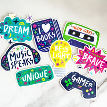 Load image into Gallery viewer, A pack of 8 vinyl, die-cut stickers featuring the words brave, unique, music speaks, good vibes, be the light, I love books.