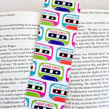 Load image into Gallery viewer, A bookmark placed inside a book. The bookmark features the words &quot;good vibes&quot; inside an illustrated cassette tape. 