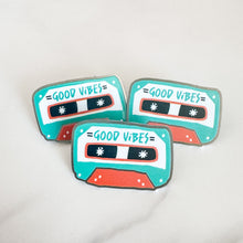 Load image into Gallery viewer, Three enamel pins featuring the words &quot;good vibes&quot; inside an illustrated cassette tape.