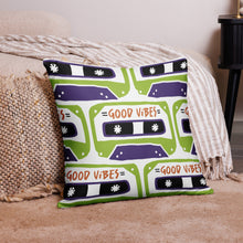 Load image into Gallery viewer, A pillow on the floor on a rug laying against a bed. The white pillow features the artwork on a white background with an illustrated cassette tape pattern with the words &#39;good vibes.&#39;