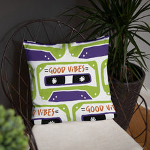 Load image into Gallery viewer, A white pillow on a chair with plants around. The white pillow features the artwork on a white background with an illustrated cassette tape pattern with the words &#39;good vibes.&#39;