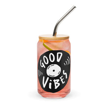 Load image into Gallery viewer, A photo of a glass can tumbler on a white background with a bamboo lid and silver metal straw. The design on the glass tumbler says the words &quot;good vibes&quot; inside an illustrated vinyl record.