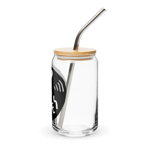 A photo of a glass can tumbler on a white background showing the side of the glass. The glass tumbler has a bamboo lid and silver metal straw. The design on the glass tumbler says the words "good vibes" inside an illustrated vinyl record.