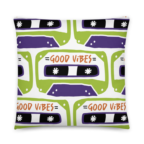 A pillow on a white background. The white pillow features the artwork on a white background with an illustrated cassette tape pattern with the words 'good vibes.'