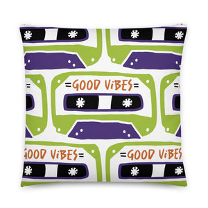 A pillow on a white background. The white pillow features the artwork on a white background with an illustrated cassette tape pattern with the words 'good vibes.'