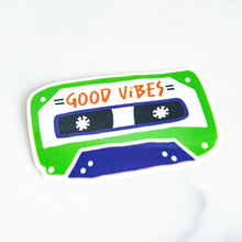 Load image into Gallery viewer, A vinyl die cut sticker with the words &quot;good vibes&quot; inside an illustrated cassette tape. 