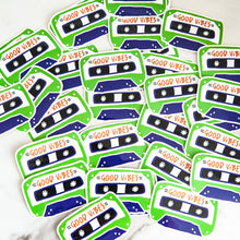 Load image into Gallery viewer, Vinyl die cut stickers with the words &quot;good vibes&quot; inside an illustrated cassette tape. 