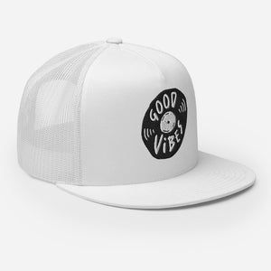 A white trucker hat on a white background showing an angel view of the hat. The hat features an black embroidered design with an illustrated vinyl record and the words 'good vibes' inside.  