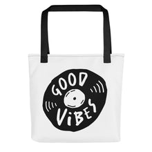 Load image into Gallery viewer, A white tote bag with black handles on a white background. The bag features a design with the words &#39;good vibes&#39; inside an illustrated vinyl record. 