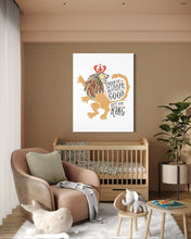 Load image into Gallery viewer, A white canvas with artwork hanging on a wall above a crib in a nursery. The artwork features an illustrated lion with a crown and reads &quot;Course He Isn&#39;t Safe, But He&#39;s Good. He&#39;s the King.&quot;