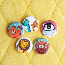 Load image into Gallery viewer, Five button pins are on a yellow background. The buttons feature illustrated cats, a bear, a penguin, a lion and a red panda.