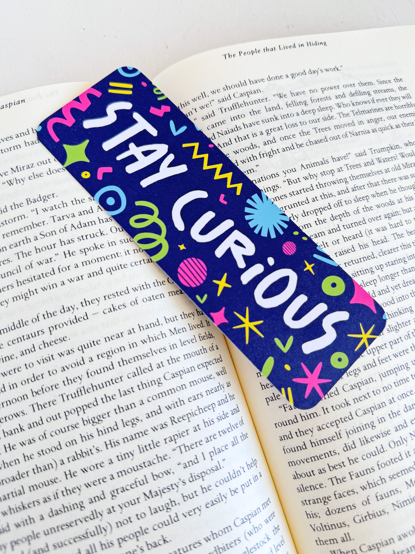 A bookmark placed inside a book. The bookmark has the words 