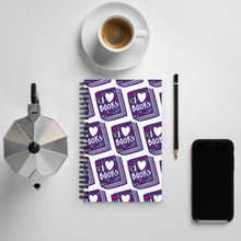 Load image into Gallery viewer, A spiral notebook on a tabletop with a coffee mug and phone around it. The white spiral notebook has black spiral binding. The pattern design features the words &quot;I love books&quot; inside an illustrated book with the word love as a heart. 