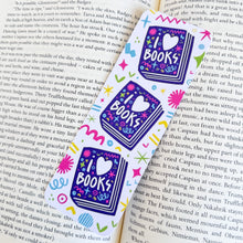 Load image into Gallery viewer, A close up of the I love books bookmark on top of a book. 