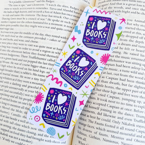 A close up of the I love books bookmark on top of a book. 