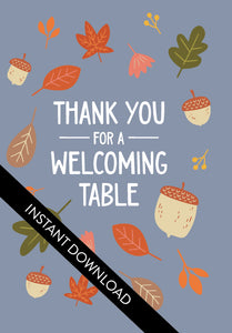 A close up of the card design with the words “instant download” over the top. The card features the words "Thank You for a Welcoming Table" with illustrated leaves and acorns around the words. 