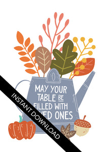 A close up of the card design with the words “instant download” over the top. The card features the words "May Your Table be Filled with Loved Ones" with the words inside an illustrated watering can with leaves coming out of the top.