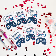 Load image into Gallery viewer, An image showing six classroom valentines on a white table. The valentine&#39;s read &quot;You&#39;ve got game&quot; with an illustrated game controller. 