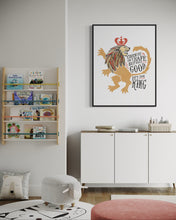 Load image into Gallery viewer, Artwork in a black frame with the with a white matte. The frame is hanging on a wall in a playroom. The artwork features an illustrated with the words &quot;Course He Isn&#39;t Safe, But He&#39;s Good. He&#39;s the King.&quot;