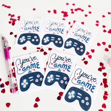 Load image into Gallery viewer, An image showing six classroom valentines on a white table. The valentine&#39;s read &quot;You&#39;ve got game&quot; with an illustrated game controller. 