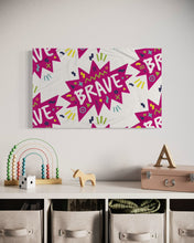 Load image into Gallery viewer, A large flag featured in a kids playroom above toy storage. The white flag features a pattern with the word &quot;brave&quot; featured inside a pink star-like shape with sketchy illustrations around the word. 