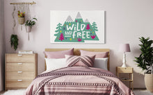 Load image into Gallery viewer, A large white flag featured on a wall of a bedroom above the bed. The white flag features the words &#39;wild and free&#39; inside illustrated mountains with sketch trees and other elements around.