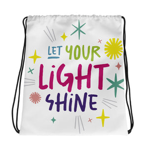 A white drawstring bag on a white background. The drawstring bag has the words "Let Your Light Shine" with sketchy illustrations around the words.