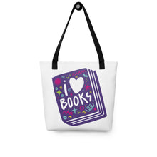 Load image into Gallery viewer, A white tote bag with black handles on a white background. The tote bag has a design with the words &#39;I love books&#39; with the word love shown as a heart. The words are inside an illustrated book. 