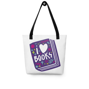 A white tote bag with black handles on a white background. The tote bag has a design with the words 'I love books' with the word love shown as a heart. The words are inside an illustrated book. 