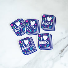 Load image into Gallery viewer, Vinyl die cut stickers featuring the words &quot;I Love Books&quot; inside an illustrated book. 