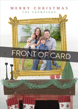 Load image into Gallery viewer, A close up of the front of the card showing the front of the card design. Across the image is a gray strip with the words “front of card” on it. The front of the card features the words “Merry Christmas” with a family name below it that can be edited. A photo is featured in an illustrated frame above an illustrated fireplace. 