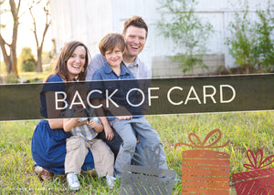 A close up of the back of the card showing the two photos and design features. Across the image is a gray strip with the words “back of card” on it. The back of the card features one photo with some more illustrated gifts. 