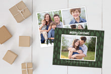 Load image into Gallery viewer, A photo of a Christmas card showing the front and back of the card laying on a white surface. Brown wrapped small gifts are to the left of the cards. The front of the card features a photo with a frame around it with illustrated pine trees. Above the photo reads “Merry Christmas” and below the photo you can add your family name. The back of the card features three photos with illustrated pine trees.