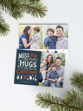 Load image into Gallery viewer, A photo of a Christmas card showing the front and back of the card laying on a white surface. Around the two sides of the card are pine needles. The front of the card features a photo on the right side and on the left side are the words “ Miss you and sending hugs to you this Christmas” with illustrated trees below the words. The back of the card features two photos with illustrated trees at the bottom.