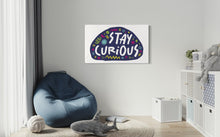 Load image into Gallery viewer, A large flag featured on a wall of a kids playroom. The white flag features the words &quot;stay curious&quot; featured inside a a purple shape with sketchy illustrations around. 