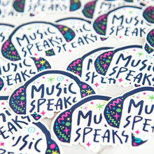 Load image into Gallery viewer, Vinyl die cut stickers with the words &quot;music speaks&quot; with illustrated headphones around the words. 