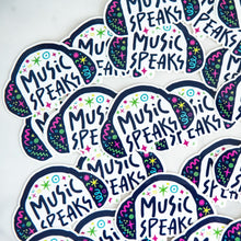 Load image into Gallery viewer, Vinyl die cut stickers with the words &quot;music speaks&quot; with illustrated headphones around the words. 