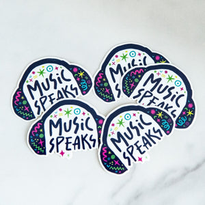 Vinyl die cut stickers with the words "music speaks" with illustrated headphones around the words. 