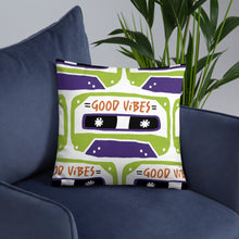 Load image into Gallery viewer, A white pillow on a blue sofa. The white pillow features the artwork on a white background with an illustrated cassette tape pattern with the words &#39;good vibes.&#39;