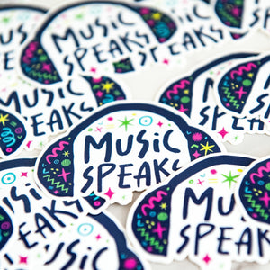 Vinyl die cut stickers with the words "music speaks" with illustrated headphones around the words. 