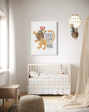 Load image into Gallery viewer, A white canvas with artwork hanging on a wall above a crib in a nursery. The artwork features an illustrated lion with a crown and reads &quot;Course He Isn&#39;t Safe, But He&#39;s Good. He&#39;s the King.&quot;