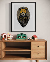 Load image into Gallery viewer, Artwork in a black frame with the with a white matte. The frame is on a wall above a dresser with children&#39;s items on top. The artwork features an illustrated Aslan (the lion from Chronicles of Narnia). Inside the lion the Narnia quote is featured reading “At The Sound of Your Roar, Sorrows Will Be No More.”